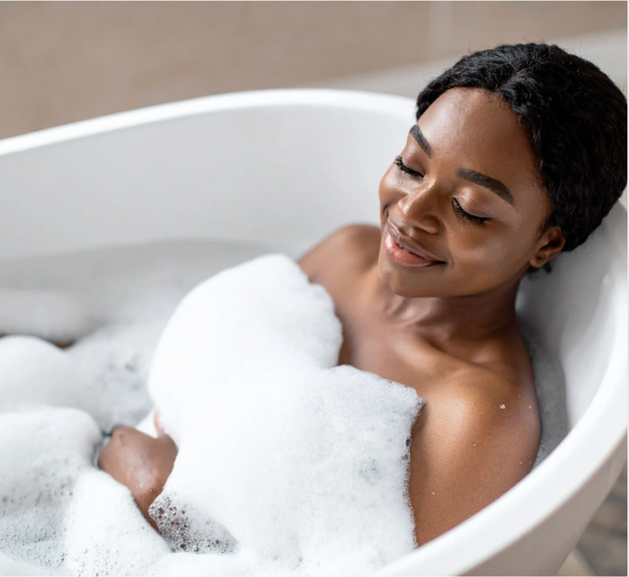 woman laying in bubble bath