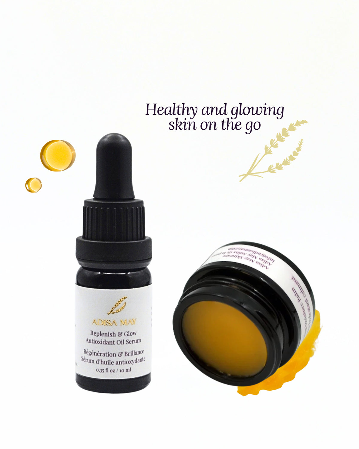 A skincare product set on a white background featuring a black dropper bottle labeled ADISA MAY  replenish & Glow Antioxidant Oil Serum' and a black jar of yellow balm with a white label, accompanied by decorative text and yellow oil droplets.