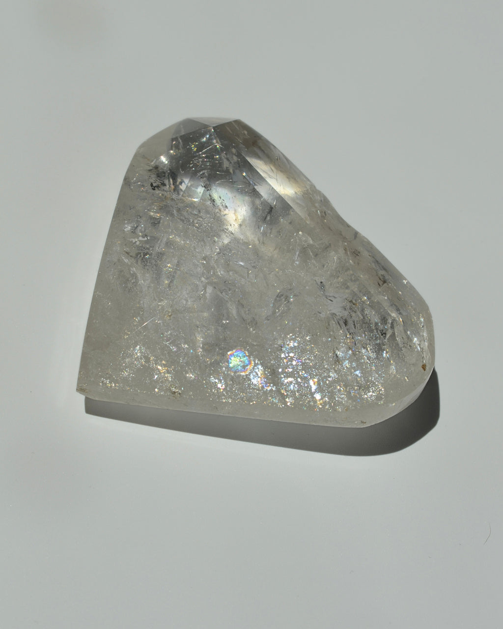 Clear quartz heart crystal on  gray background