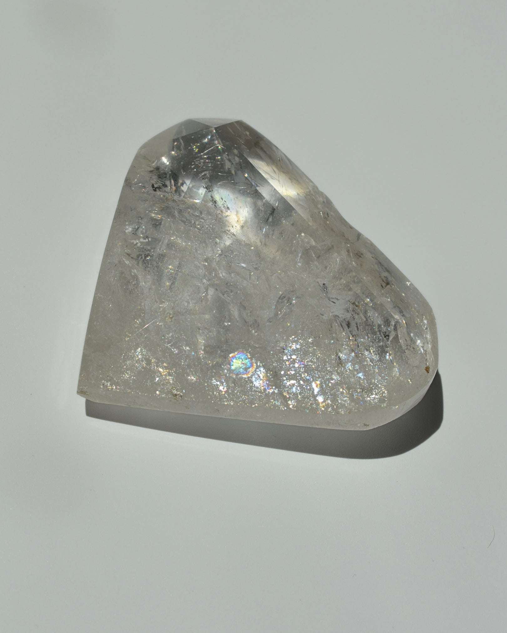 Clear quartz heart crystal on  gray background
