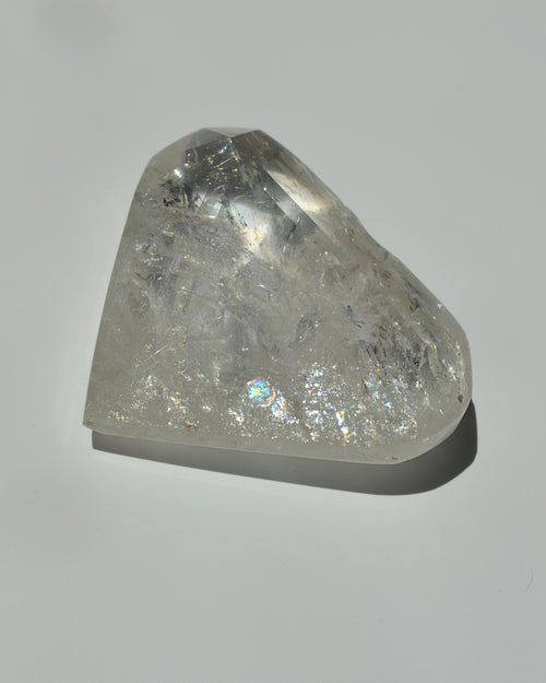 Clear quartz heart crystal on  gray background