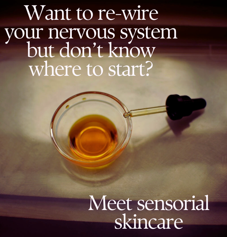 Glass with amber liquid and dropper on a white surface, with text about sensorial skincare.