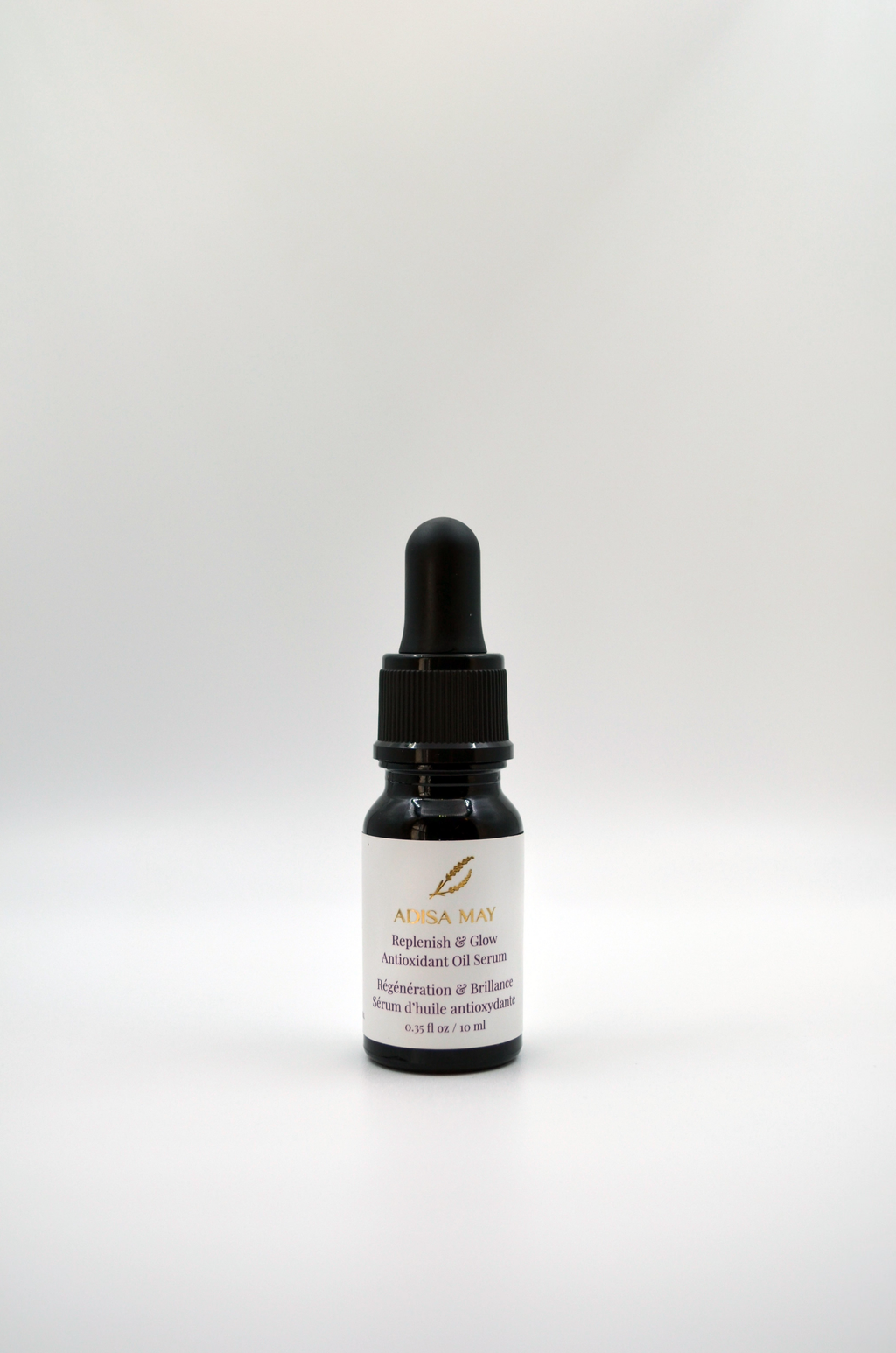 Black dropper bottle with a white label over it