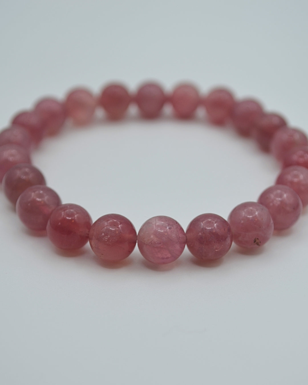 Pink beaded bracelet on a white background