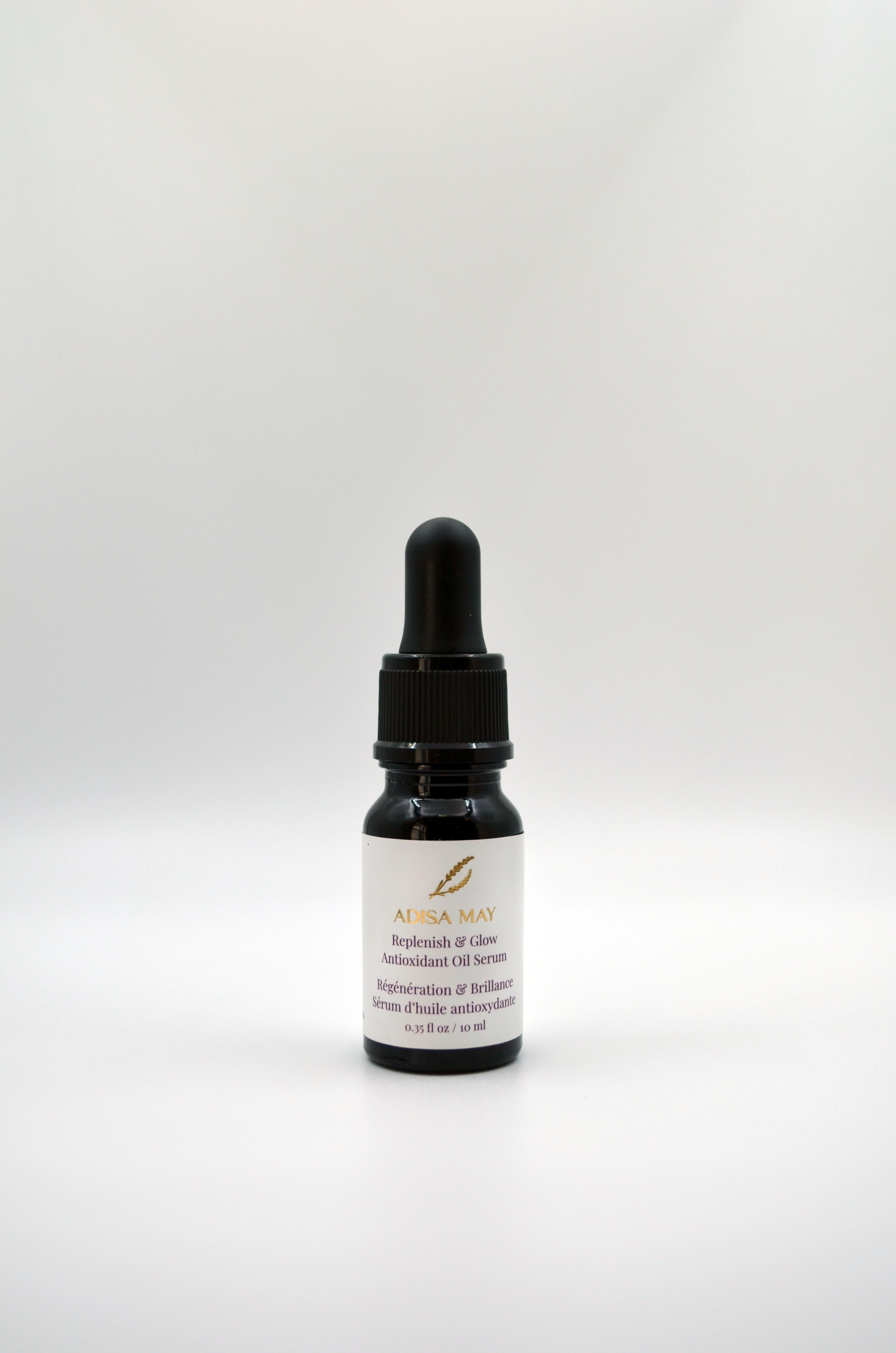 Black dropper bottle with a white label on a light gray background