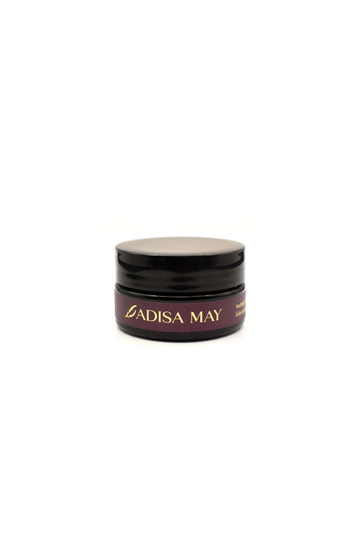 Black jar with Adisa May branding on a white background
